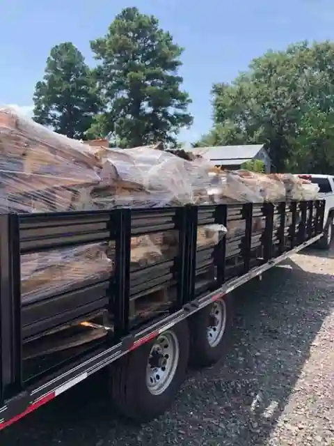 A flatbed trailer loaded with oak rounds